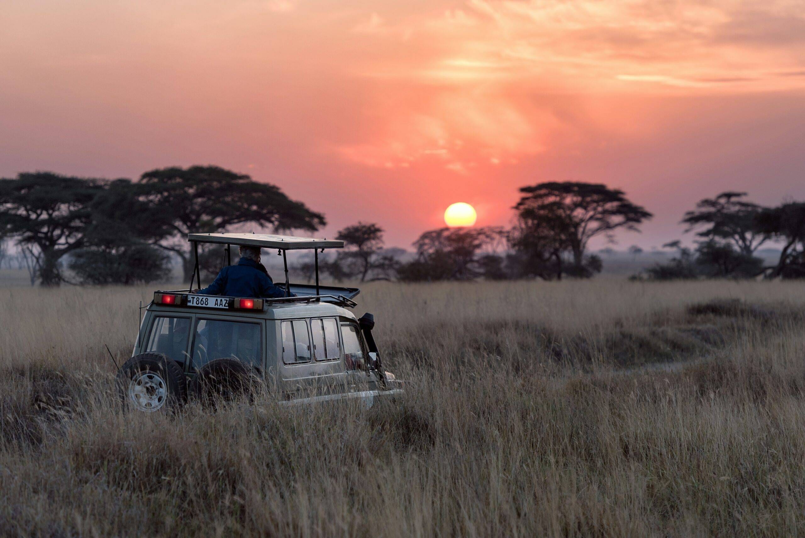 family safari packages in Uganda with safari jeep during game drive