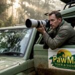 Photographer in safari vehicle on Uganda track
