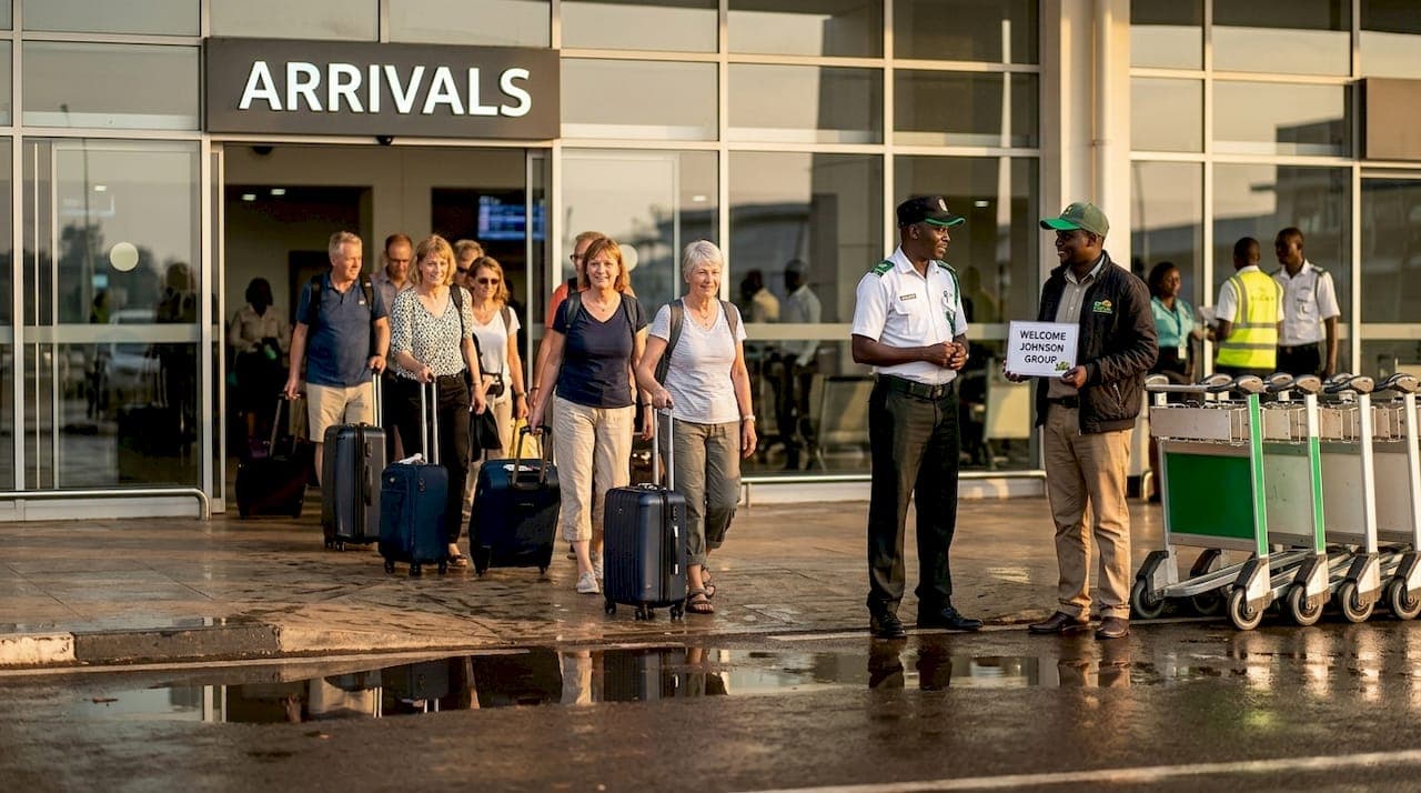 Travelers exiting Entebbe Airport arrivals area