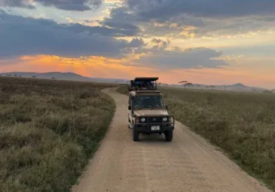 Safari 4x4 vehicle in Uganda savannah representing a local Uganda safari tour operator