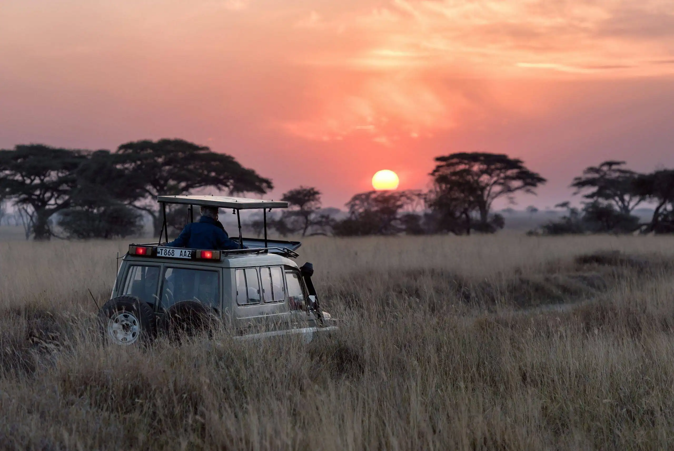 family safari packages in Uganda with safari jeep during game drive
